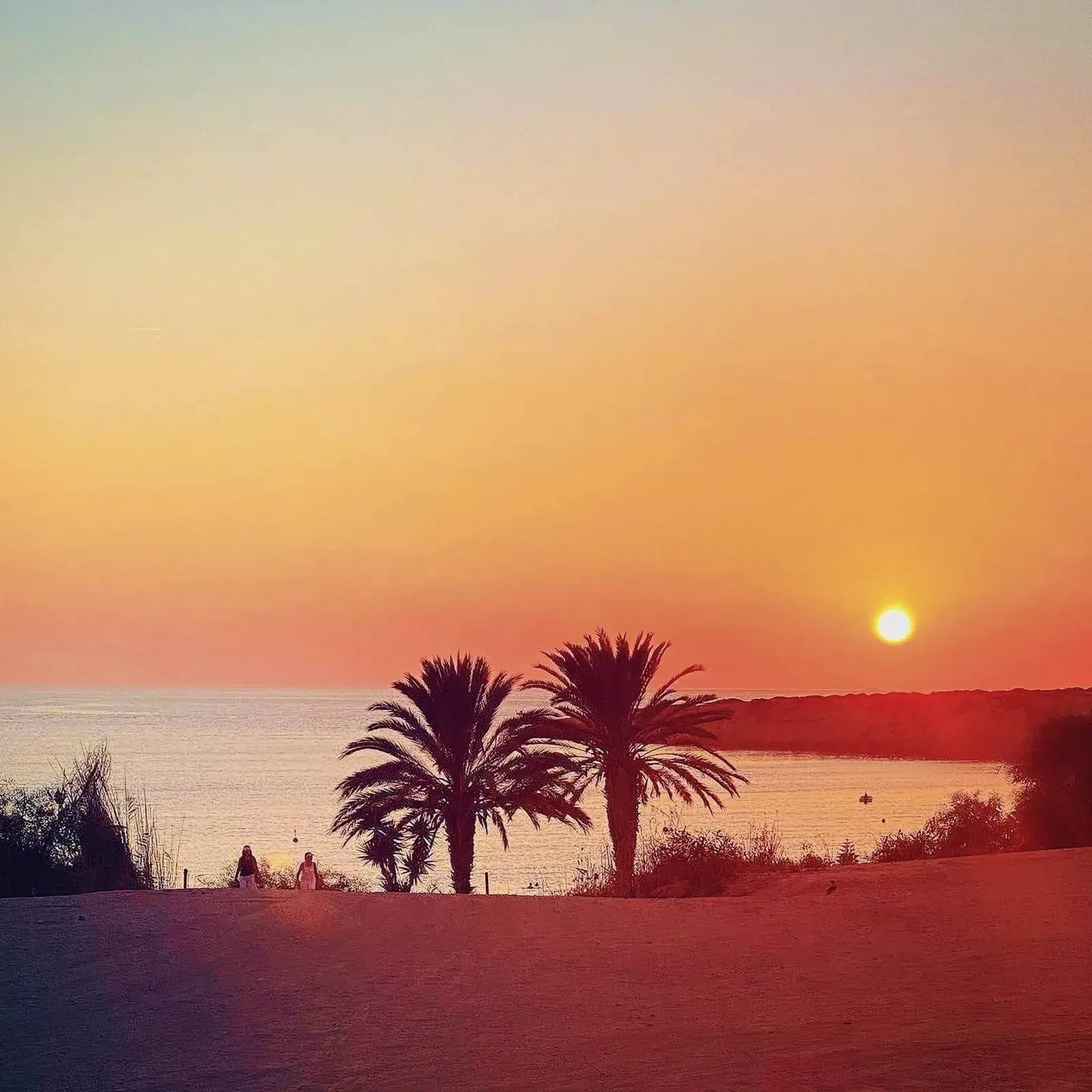 Serene tropical sunset over a tranquil beach.