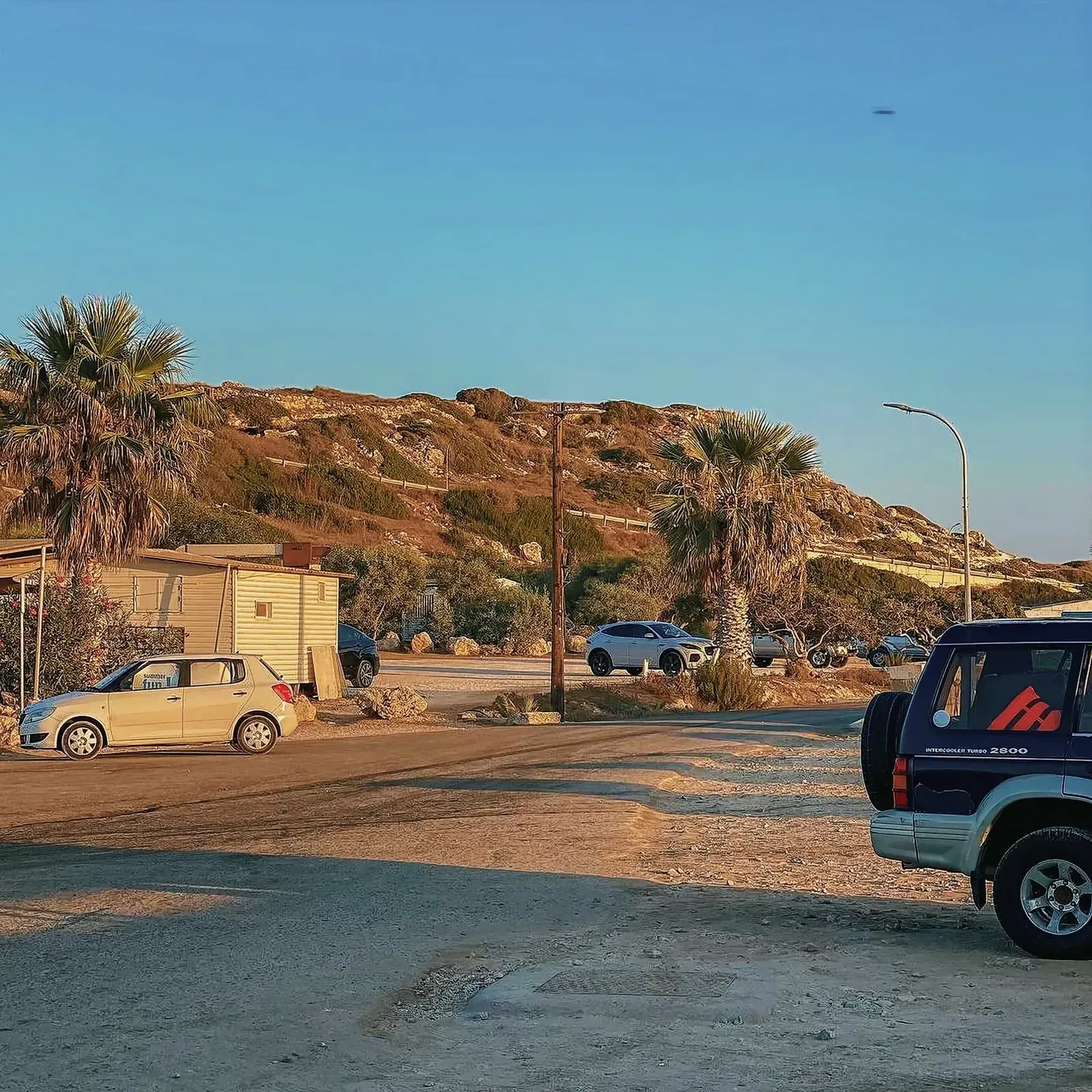 Picture-perfect outdoor scene with cars parked along a road in Akamas National Park.