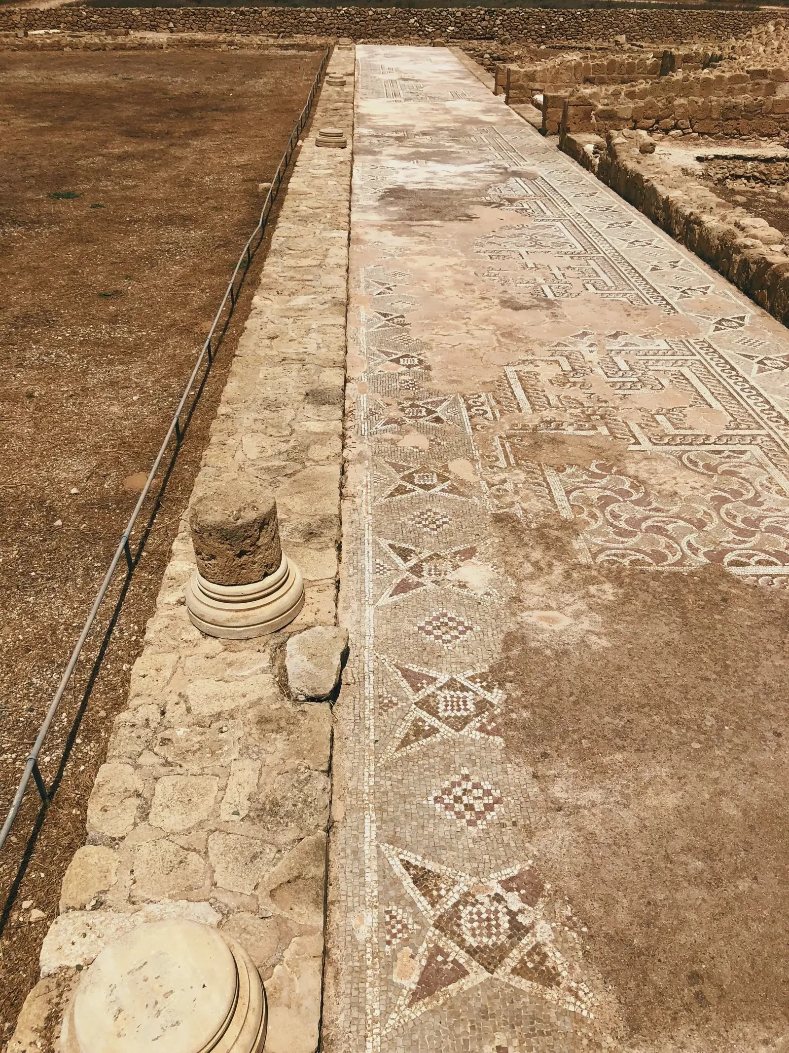 Stone path leading to a stone pillar in Nea Paphos
