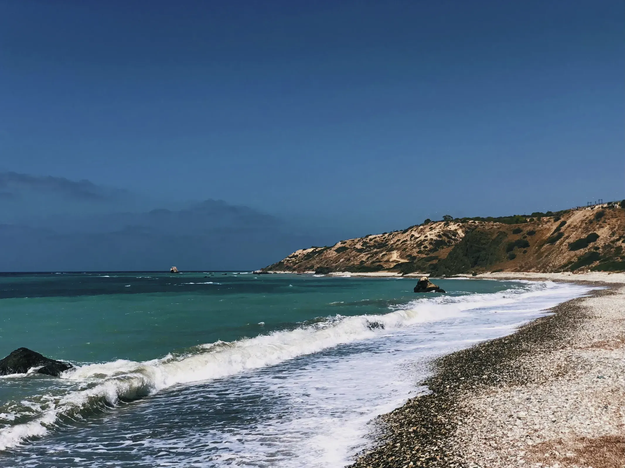 Aphrodite’s Rock - Waves crashing dramatically on a beach, providing an awe-inspiring view of the shoreline.