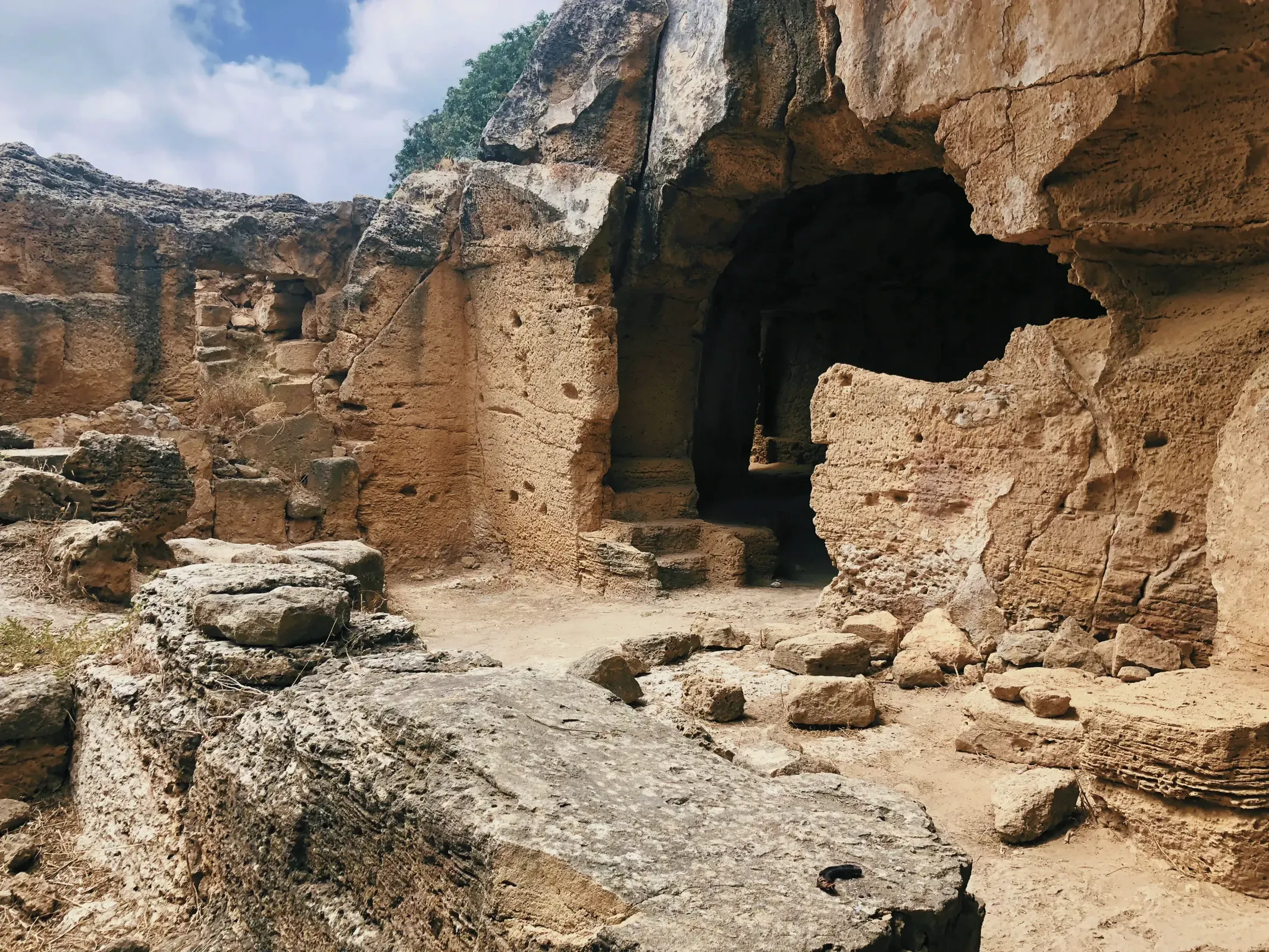 Massive rock structure with a distinctive hole resembling a window or entryway.